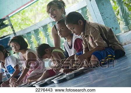 Orphan children from The Nun's School or Karen Refugee Orphanage (Pimjai Nun Temple) run by a buddhist nun and a popular student gap year volenteer experience; Sangkhla Buri, Kanchanaburi, Thailand View Large Photo Image Stock Image - Orphan children from The Nun's School or Karen Refugee Orphanage (Pimjai Nun Temple) run by a buddhist nun and a popular student gap year volenteer experience; Sangkhla Buri, Kanchanaburi, Thailand. Fotosearch