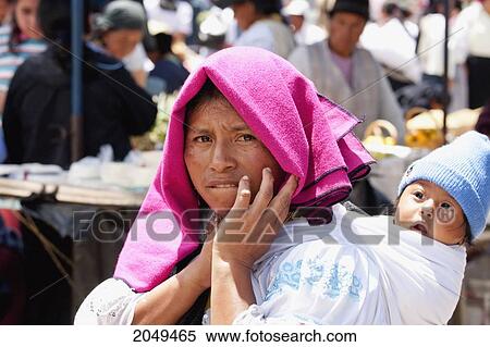 Stock Photography - Otavaleno Woman Carrying A Baby, Otavalo, Imbabura, Ecuador. Fotosearch