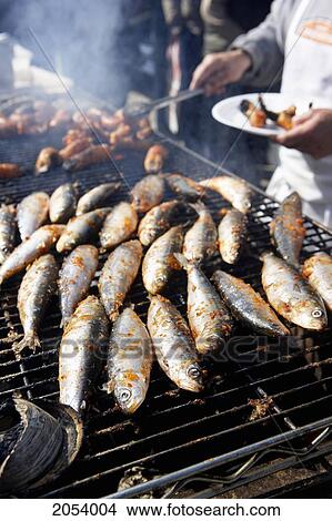 Picture - Outdoor Bbq Grilling Sardines, Kensington Market, Toronto. Fotosearch