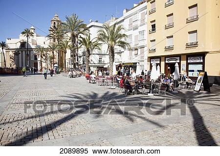 Stock Photography - Outdoor Cafe And Palm Trees In A Town Square; Cadiz, Andalusia, Spain. Fotosearch