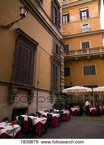 Stock Photo - Outdoor Restaurant In Cosy Courtyard; Rome, Italy. Fotosearch