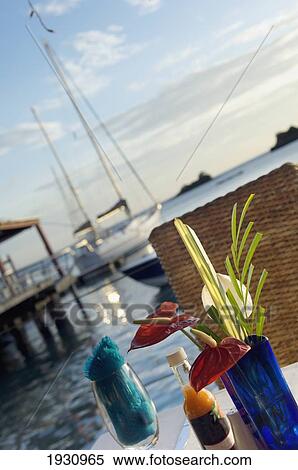 Outdoor Table Settings At The Dodgy Dock Restaurant And Lounge Bar Near The Ocean With Sail Boats Behind. Blue Vase With Flowers, Wine Glass; Grenada, Caribbean View Large Photo Image Stock Photography - Outdoor Table Settings At The Dodgy Dock Restaurant And Lounge Bar Near The Ocean With Sail Boats Behind. Blue Vase With Flowers, Wine Glass; Grenada, Caribbean. Fotosearch