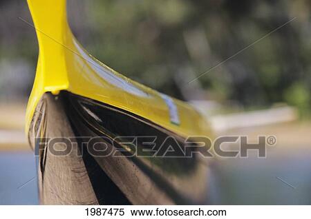 Stock Photography - Outrigger Canoe, Close-Up Detail Of Black And Yellow Hull, Blurred Background.. Fotosearch