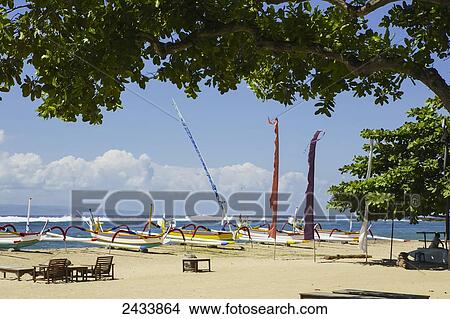 Picture - Outrigger canoes await passengers on Sanur Beach; Bali, Indonesia. Fotosearch