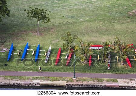 Picture - Outrigger canoes stored next to the Ala Wai Canal; Waikiki, Oahu, Hawaii, United States of America. Fotosearch