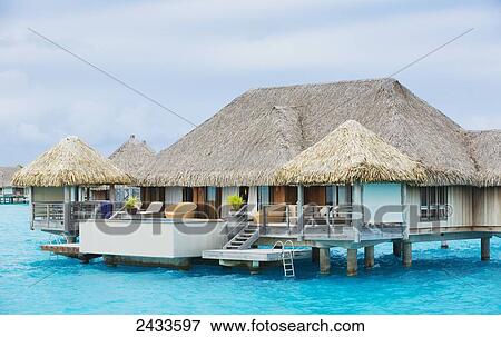 Stock Photo - Over-water bungalow at a tropical resort; Bora Bora, French Polynesia. Fotosearch