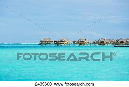 Stock Image - Over-water bungalows at a tropical resort; Bora Bora, French Polynesia. Fotosearch
