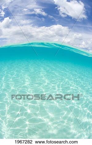 Over/Under View Of Shallow Ocean Water And Sky Above. View Large Photo Image Stock Image - Over/Under View Of Shallow Ocean Water And Sky Above.. Fotosearch