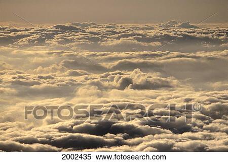 Stock Photography - Overview Of Cloud Layer In Pale Yellow Green Skies, Dark Gray Shadows. Fotosearch
