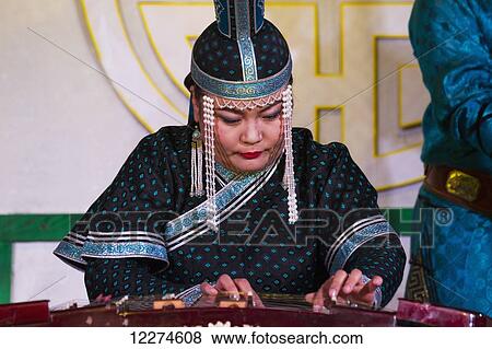 P. Nyamsuren playing Yoochin (Dulcimer) in a performance of the Tumen Ekh Mongolian National Song & Dance Ensemble in Ulaanbaatar (Ulan Bator), Mongolia View Large Photo Image Stock Photo - P. Nyamsuren playing Yoochin (Dulcimer) in a performance of the Tumen Ekh Mongolian National Song & Dance Ensemble in Ulaanbaatar (Ulan Bator), Mongolia. Fotosearch