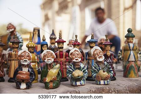 Stock Photo - Painted figures in a souvenir stall, inside Ichan Kala Old City; Khiva, Khwarezm, Uzbekistan. Fotosearch