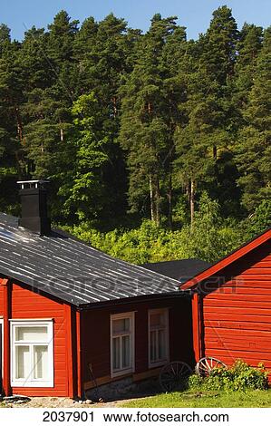 Stock Image - Painted Red Riverside Houses On The River; Porvoo Finland. Fotosearch