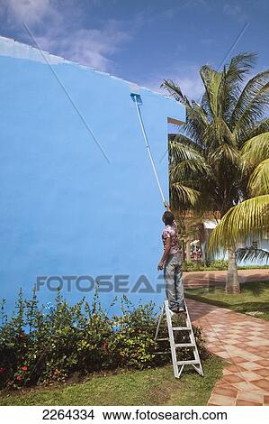 Painting a wall in a tourist resort; marea del portillo cuba View Large Photo Image Picture - Painting a wall in a tourist resort; marea del portillo cuba. Fotosearch