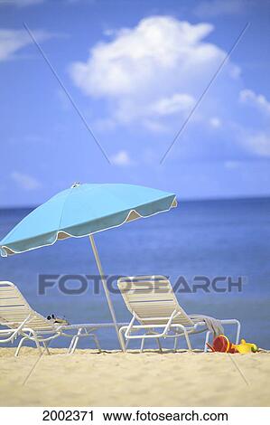 Pair Of Beach Chairs And An Umbrella On White Sand Beach With Blue Skies And Water View Large Photo Image Stock Image - Pair Of Beach Chairs And An Umbrella On White Sand Beach With Blue Skies And Water. Fotosearch