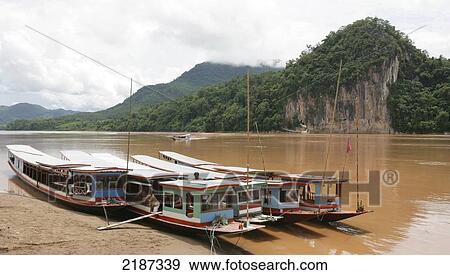 Stock Photo - Pak Ou Caves on the Mekong River; Luang Prabang, Laos. Fotosearch