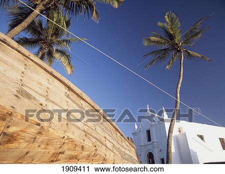Palms Trees And Hull Of Fishing Boat Beside The Church Of Santo Antonio, Ilha De Mocambique, Mozambique. View Large Photo Image Stock Image - Palms Trees And Hull Of Fishing Boat Beside The Church Of Santo Antonio, Ilha De Mocambique, Mozambique.. Fotosearch