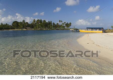 Picture - Panama, San Blas Islands (also called Kuna Yala Islands), Yandup Island, small beach with boat at the dock.. Fotosearch