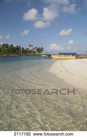 Stock Image - Panama, San Blas Islands (also called Kuna Yala Islands), Yandup Island, small beach with boat at the dock.. Fotosearch