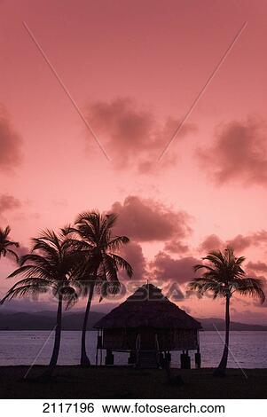 Stock Photograph - Panama, San Blas Islands (also called Kuna Yala Islands), Yandup Island, sunrise over the water hut.. Fotosearch