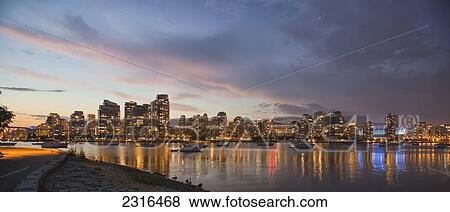 Stock Photo - Panoramic Of Sunset Over False Creek And City Skyline; Vancouver British Columbia Canada. Fotosearch
