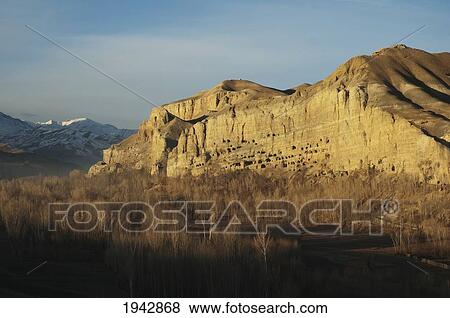 Panoramic View Of Bamiyan And The Escarpment With Hundreds Of Caves, Bamian Province, Afghanistan View Large Photo Image Stock Photo - Panoramic View Of Bamiyan And The Escarpment With Hundreds Of Caves, Bamian Province, Afghanistan. Fotosearch