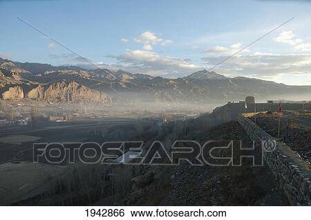 Panoramic View Of Bamiyan And The Escarpment From The Hill In The Morning Mist, Bamian Province, Afghanistan View Large Photo Image Stock Photograph - Panoramic View Of Bamiyan And The Escarpment From The Hill In The Morning Mist, Bamian Province, Afghanistan. Fotosearch