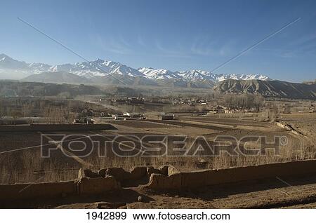Panoramic View Of Bamiyan With The Hindu Kush Mountains In The Background, Bamian Province, Afghanistan View Large Photo Image Stock Photo - Panoramic View Of Bamiyan With The Hindu Kush Mountains In The Background, Bamian Province, Afghanistan. Fotosearch