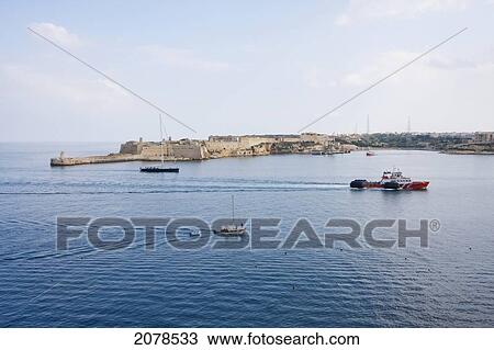 Stock Image - Panoramic View Of The Grand Harbour And The Breakers Lighthouse And Ricasoli Fort From Valletta, Kalkara, Malta. Fotosearch