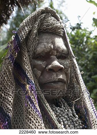 Stock Image - Papua New Guinea, Tari Valley, Widow; Tigibi Village. Fotosearch