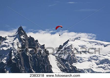 Paraglider above Chamonix-Mont Blanc valley, with Mont Blanc massif range mountain and Aiguille du Midi in background; France View Large Photo Image Stock Photo - Paraglider above Chamonix-Mont Blanc valley, with Mont Blanc massif range mountain and Aiguille du Midi in background; France. Fotosearch