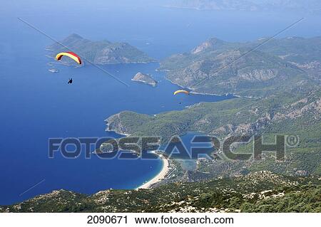 Paragliders At Mt Babadag (1950 Meters) To Oludeniz At The Turquoise Coast, Southern Turkey View Large Photo Image Stock Image - Paragliders At Mt Babadag (1950 Meters) To Oludeniz At The Turquoise Coast, Southern Turkey. Fotosearch