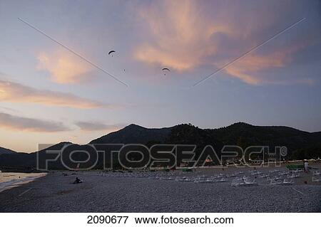 Paragliders At Sunset Over Oludeniz At The Turquoise Coast, Southern Turkey View Large Photo Image Stock Photo - Paragliders At Sunset Over Oludeniz At The Turquoise Coast, Southern Turkey. Fotosearch
