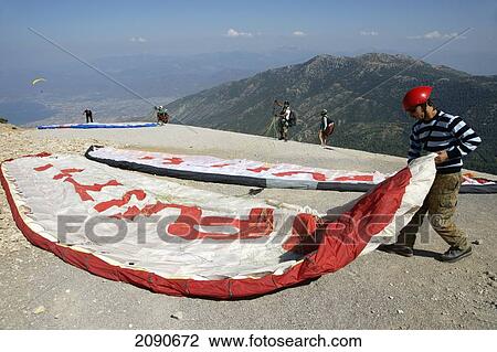 Paragliders Preparing To Make The Descent From Mt Babadag (1950 Meters) To Oludeniz At Turquoise Coast, Southern Turkey View Large Photo Image Stock Image - Paragliders Preparing To Make The Descent From Mt Babadag (1950 Meters) To Oludeniz At Turquoise Coast, Southern Turkey. Fotosearch