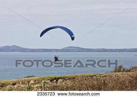 Paragliding Above Beach Near St David's; Newgale Beach, Pembrokeshire Coast, Wales, Uk View Large Photo Image Stock Image - Paragliding Above Beach Near St David's; Newgale Beach, Pembrokeshire Coast, Wales, Uk. Fotosearch