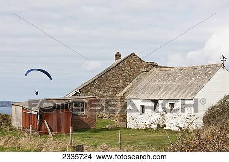 Paragliding Above Newgale Beach And Stone Cottage Barn Along Pembrokeshire Coast Near St David's; Wales, Uk View Large Photo Image Picture - Paragliding Above Newgale Beach And Stone Cottage Barn Along Pembrokeshire Coast Near St David's; Wales, Uk. Fotosearch