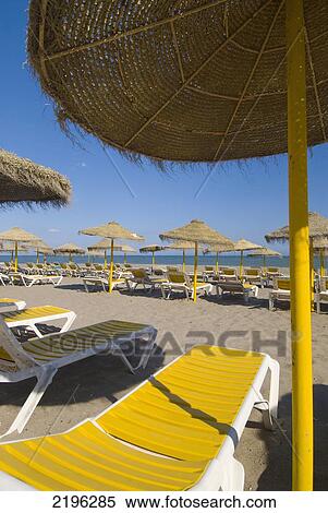 Parasols And Sun Chairs On Empty Beach, Torremolinos, Andalucia, Spain. View Large Photo Image Stock Photography - Parasols And Sun Chairs On Empty Beach, Torremolinos, Andalucia, Spain.. Fotosearch