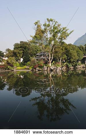 Park Along The Water's Edge Reflected In The Water; Yangshuo, Guangxi, China View Large Photo Image Stock Image - Park Along The Water's Edge Reflected In The Water; Yangshuo, Guangxi, China. Fotosearch