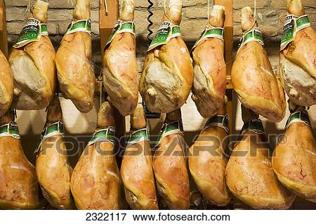 Stock Photo - Parma hams hanging in store display; Parma, Emilia-Romagna, Italy. Fotosearch