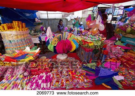 Stock Image - Party Favours And Decorations Vendor At The Jueves De Comadres Market During Carnaval Chapaco, Tarija, Bolivia. Fotosearch