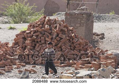 Pashtun Boy Running By A Pile Of Bricks, Khyber Pass, Federally Administered Tribal Areas, Pakistan View Large Photo Image Stock Photo - Pashtun Boy Running By A Pile Of Bricks, Khyber Pass, Federally Administered Tribal Areas, Pakistan. Fotosearch