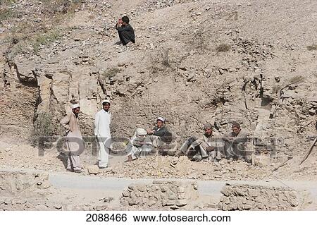 Stock Photograph - Pashtun Men Sitting By The Road In Khyber Pass, Federally Administered Tribal Areas, Pakistan. Fotosearch