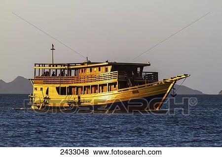 Passenger boat in Kima Bay by Rinca Island, Komodo National Park, East Nusa Tenggara, Indonesia View Large Photo Image Stock Photo - Passenger boat in Kima Bay by Rinca Island, Komodo National Park, East Nusa Tenggara, Indonesia. Fotosearch