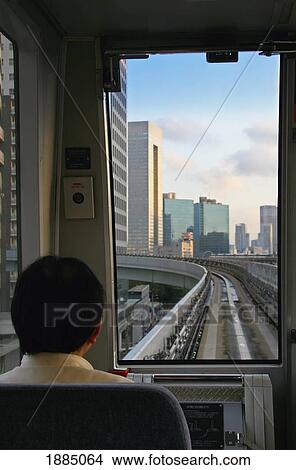 Picture - Passenger Seated On Monorail On The Way To Odaiba. Fotosearch