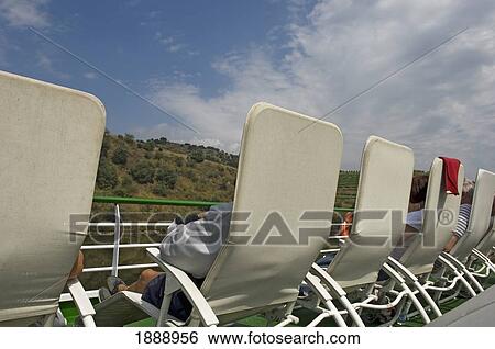 Passengers Relaxing On Sunloungers Aboard A River Cruise View Large Photo Image Stock Photograph - Passengers Relaxing On Sunloungers Aboard A River Cruise. Fotosearch