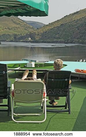 Picture - Passengers Resting On Deck Of A River Cruise. Fotosearch