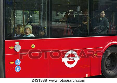 Passengers ride a city bus; London, England View Large Photo Image Stock Photo - Passengers ride a city bus; London, England. Fotosearch