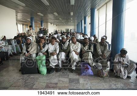 Stock Image - Passengers Waiting At The Main Terminal Building Of The Kabul International Airport For The Departure Of Their Flight,, Afghanistan. Fotosearch