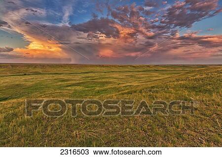 Stock Image - Passing Storm Over The Prairies In Grasslands National Park; Saskatchewan Canada. Fotosearch