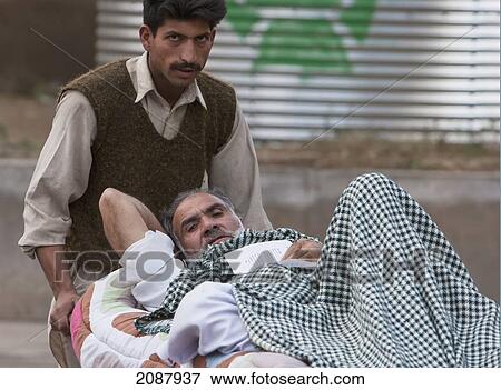 Patient On A Stretcher By A Polyclinic After The 8 October 2005 Earthquake, Muzaffarabad, Azad Kashmir, Pakistan View Large Photo Image Stock Photo - Patient On A Stretcher By A Polyclinic After The 8 October 2005 Earthquake, Muzaffarabad, Azad Kashmir, Pakistan. Fotosearch
