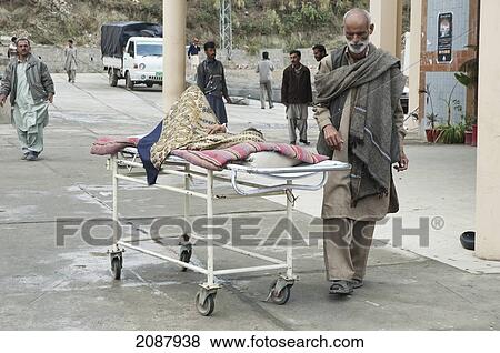 Patient On A Stretcher By A Polyclinic After The 8 October 2005 Earthquake, Muzaffarabad, Azad Kashmir, Pakistan View Large Photo Image Stock Photo - Patient On A Stretcher By A Polyclinic After The 8 October 2005 Earthquake, Muzaffarabad, Azad Kashmir, Pakistan. Fotosearch